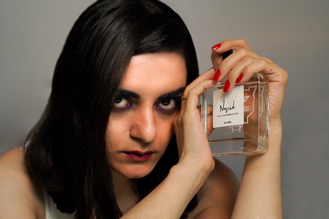 Woman testing perfume on her wrist and waiting for the drydown